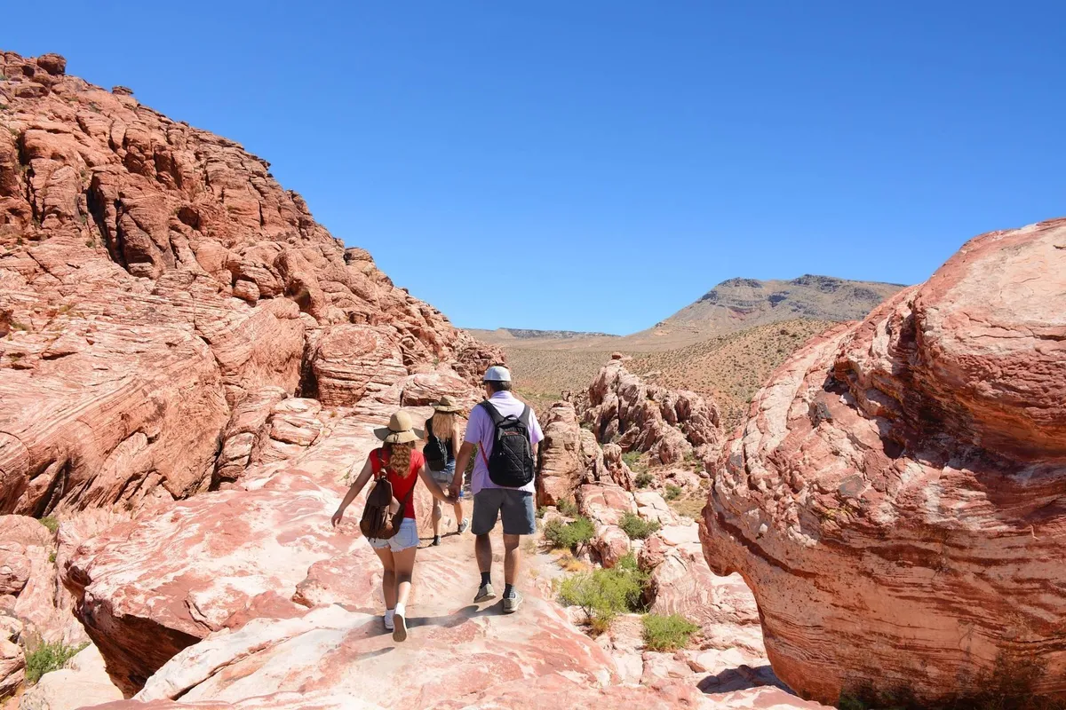 A dramatic Arizona landscape with red rock formations, a winding natural pathway, and distant mountains—a striking representation of the area's outdoor adventure opportunities beyond the property.